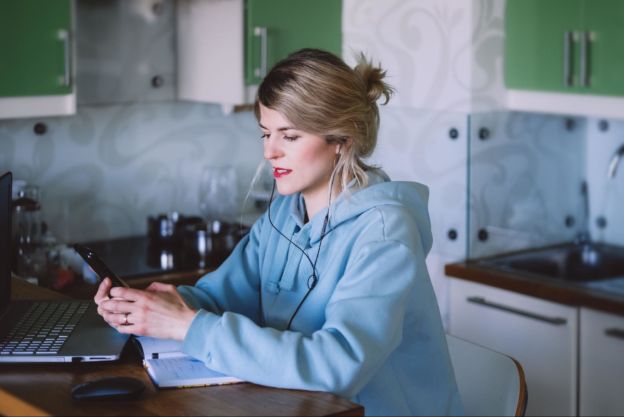 Woman wearing hoodie calling a local utility provider